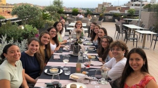 FinalDinner2023x320 Students enjoy their final dinner on a Roman roof with Dr. Romani, Program Director.