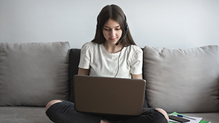 Student on a laptop wearing headphones