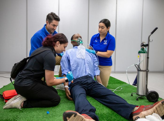 SHU athletic training students working with mannequin