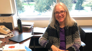 Peggy Brady-Amoon sitting in her office 