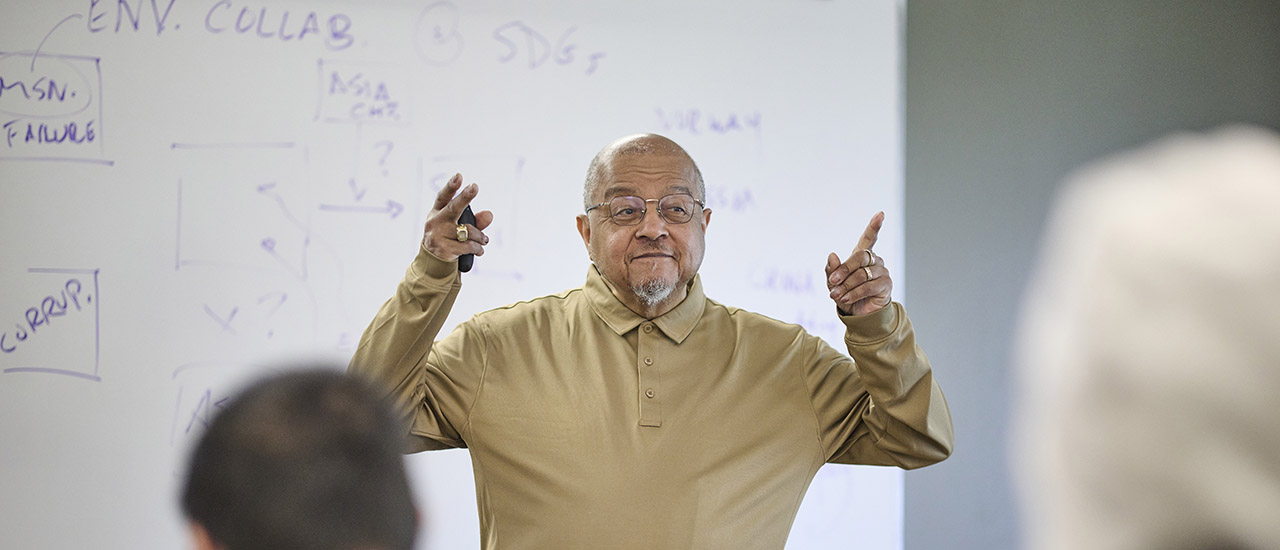 Rev. Forrest Pritchett teaching a class. Professor leading lecture