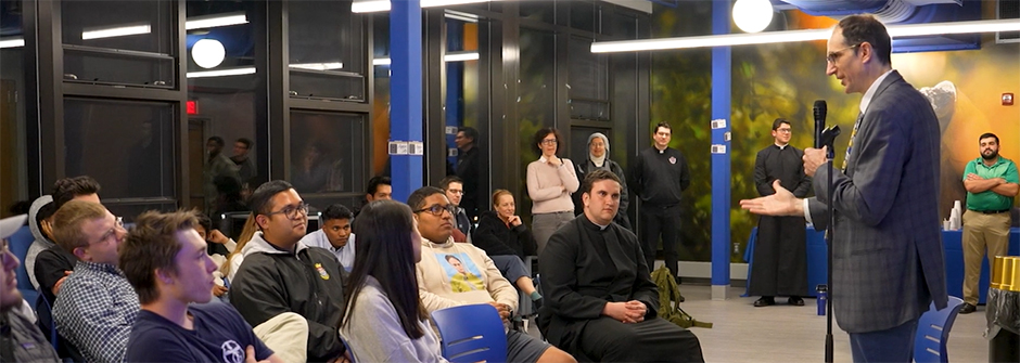 Image of a speaker talking to students in an Agape Latte setting.
