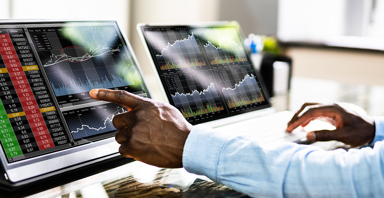A person pointing to data on a computer screen. A person pointing to data on a computer screen.