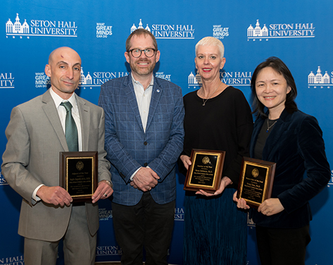 A photo of Seton Hall professors posing with their awards