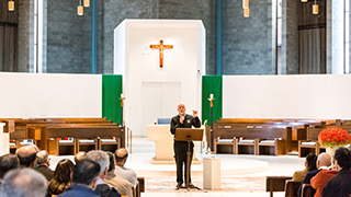 a photo of a deacon leading church community a photo of a deacon leading church community