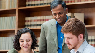 Faculty and Students working in a library Faculty and Students working in a library