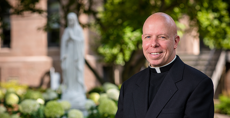 Father Colin Kay at Seton Hall Father Colin Kay at Seton Hall in front of Blessed Mother statue