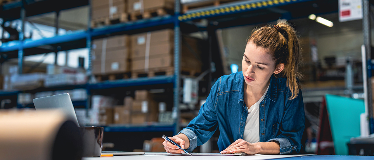 Global Supply Chain Management Student working in a warehouse.