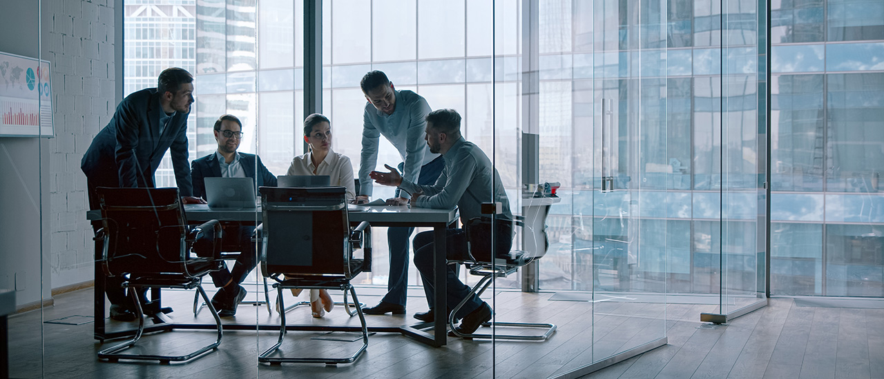 Pincipled Transparency People sitting around a conference table in a business setting.