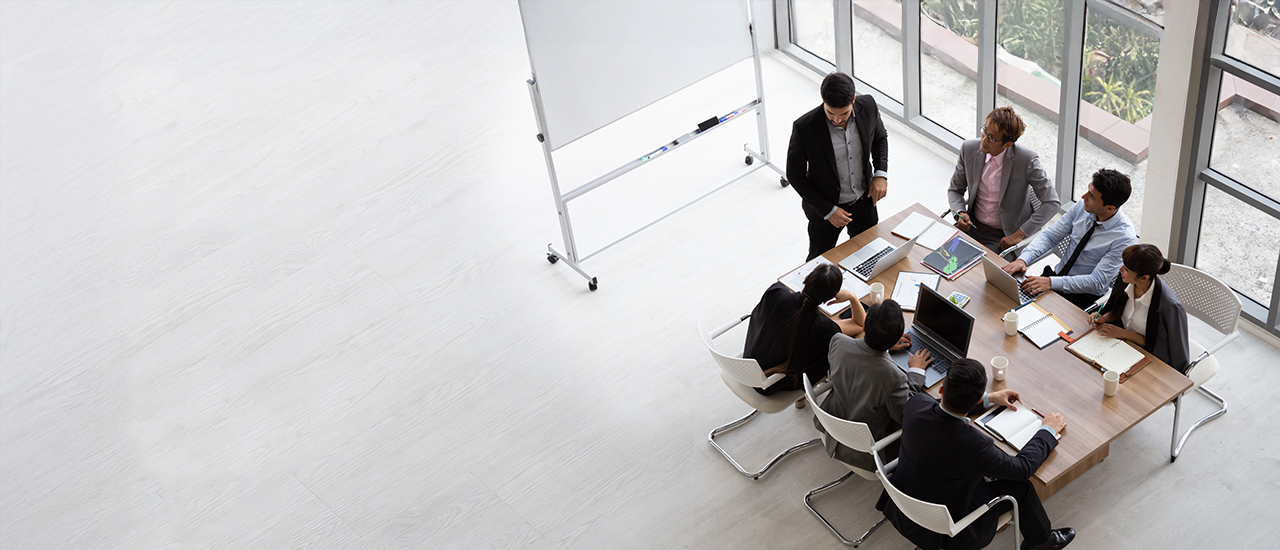 Business People Around a Conference Table People in sitting around a conference table in a business setting.