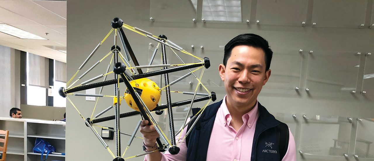 In the Lead With Jordan Sun Jordan Sun posing with a model of a device.