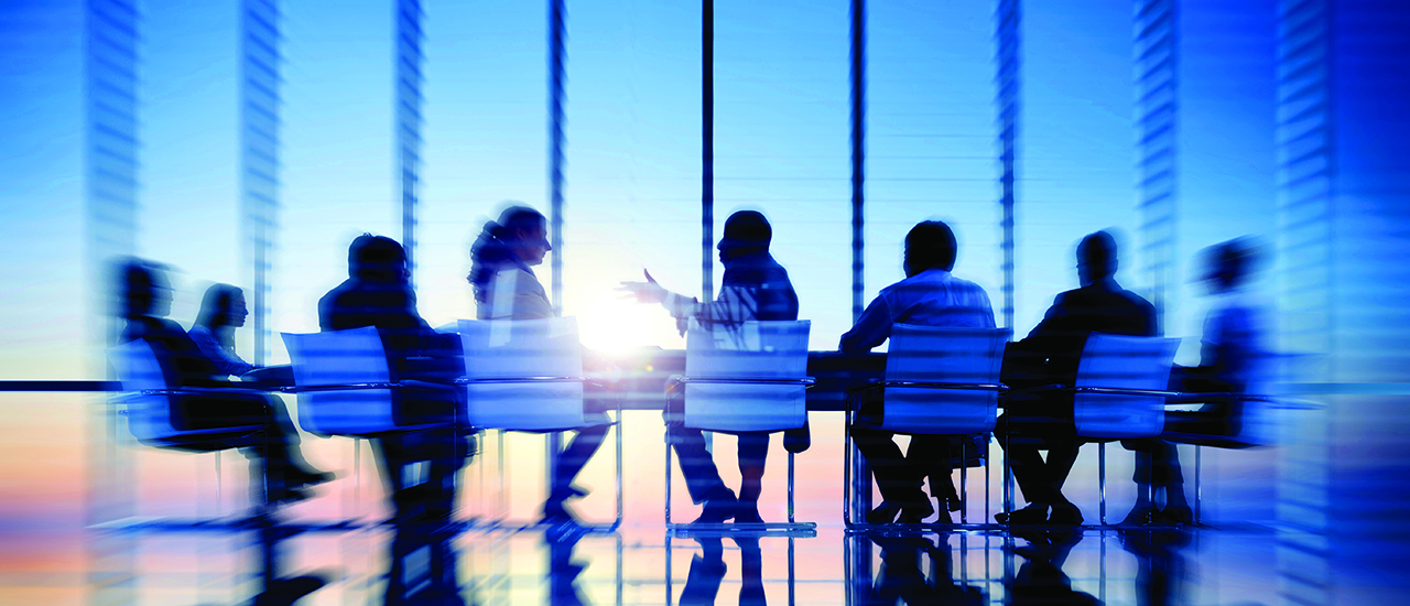Next Generation Evidence for Leadership Effectiveness People sitting around a conference table in an office building.