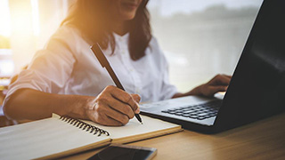 A photo of someone using a laptop.