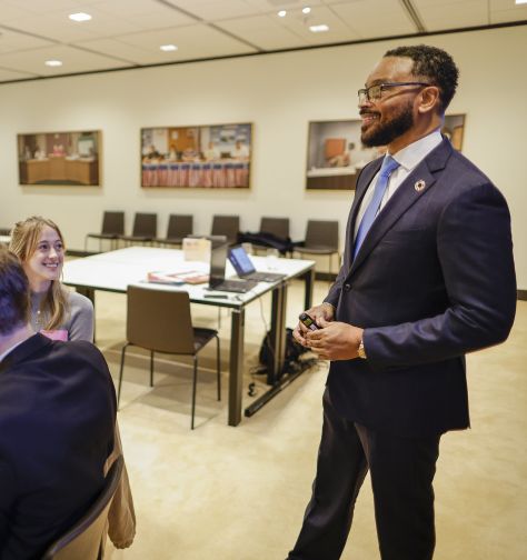 A photo of a SHU student speaking with colleagues