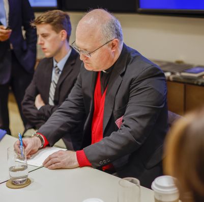 An image of a SHU student speaking to colleagues