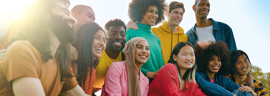 Men and women in a group hanging out outside