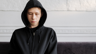 Student sitting in a hoodie 