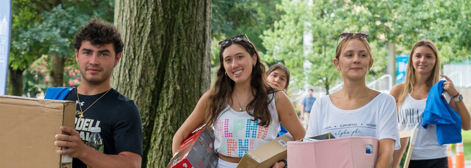 Students bringing in boxes during move-in day.