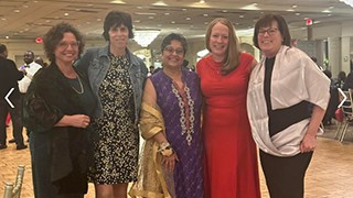 Munira Wells (center) with colleagues