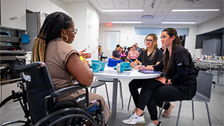 M.S.O.T interacting with a patient.