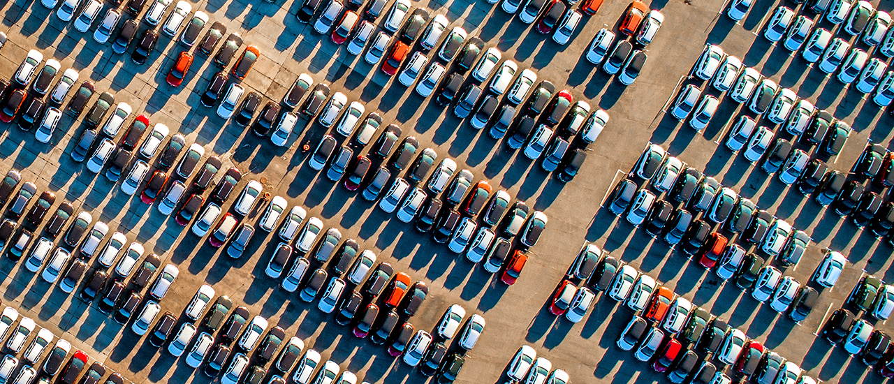 Buy-in Bloom A parking lot full of cars.