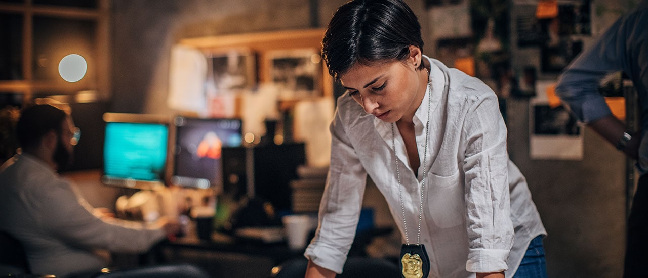 Police woman studying something on a desk Police woman studying something on a desk