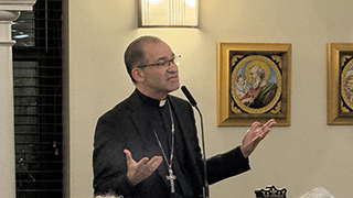 Preaching as Hospitality Image of a clergy member preaching wearing a cross