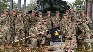 A group of ROTC Cadets A group of ROTC Cadets with a tank in the background.