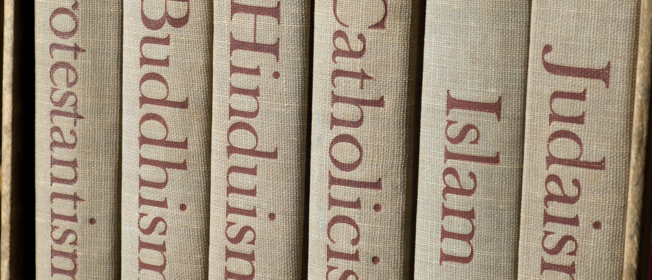 Spines of books on world religions.