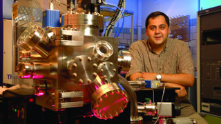 Mehmet Sahiner next to machine Mehmet Sahiner next to a machine.