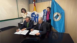 Salgado Signing with Seton Hall flag behind him