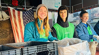 Students volunteering during an event Students volunteering during an event