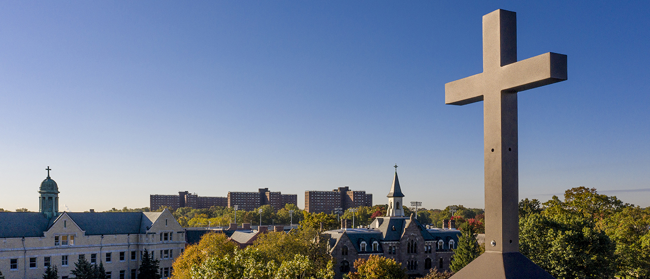 Campus Aerial View with Cross An aerial view of campus with a focus on a Cross on the top of one of the buildings.