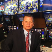 stevejavie1x222 Man smiling for a photo with monitors in the background