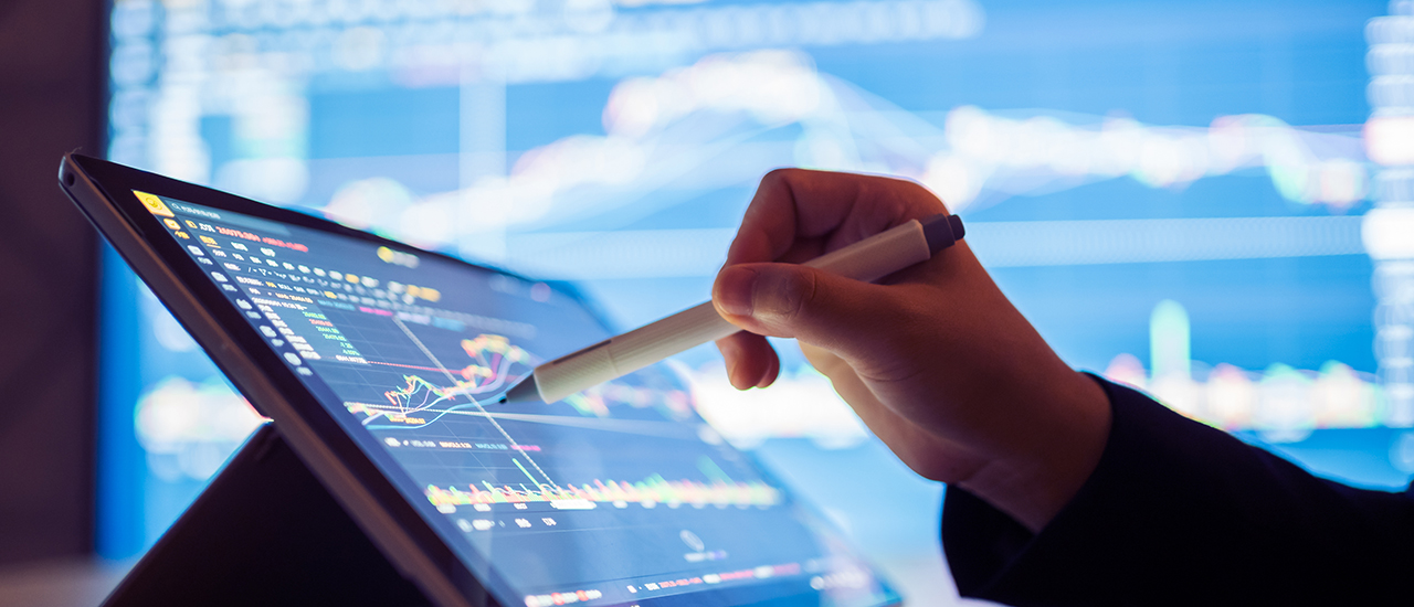 Stock Market Data A person looking at stock market data on a tablet.