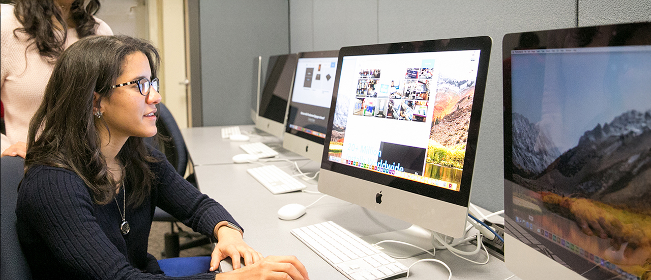 User Experience and Interface (UX/UI) Design Certificate Programs A student working on a design project on a computer.