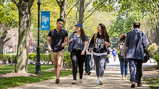 Students talking and hanging out on the University Green at Seton Hall.
